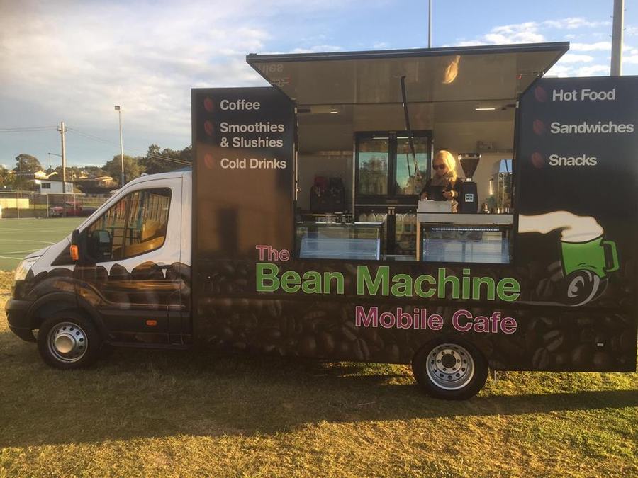 A food truck with the servery hatch up, kitchen visible behind the counter.