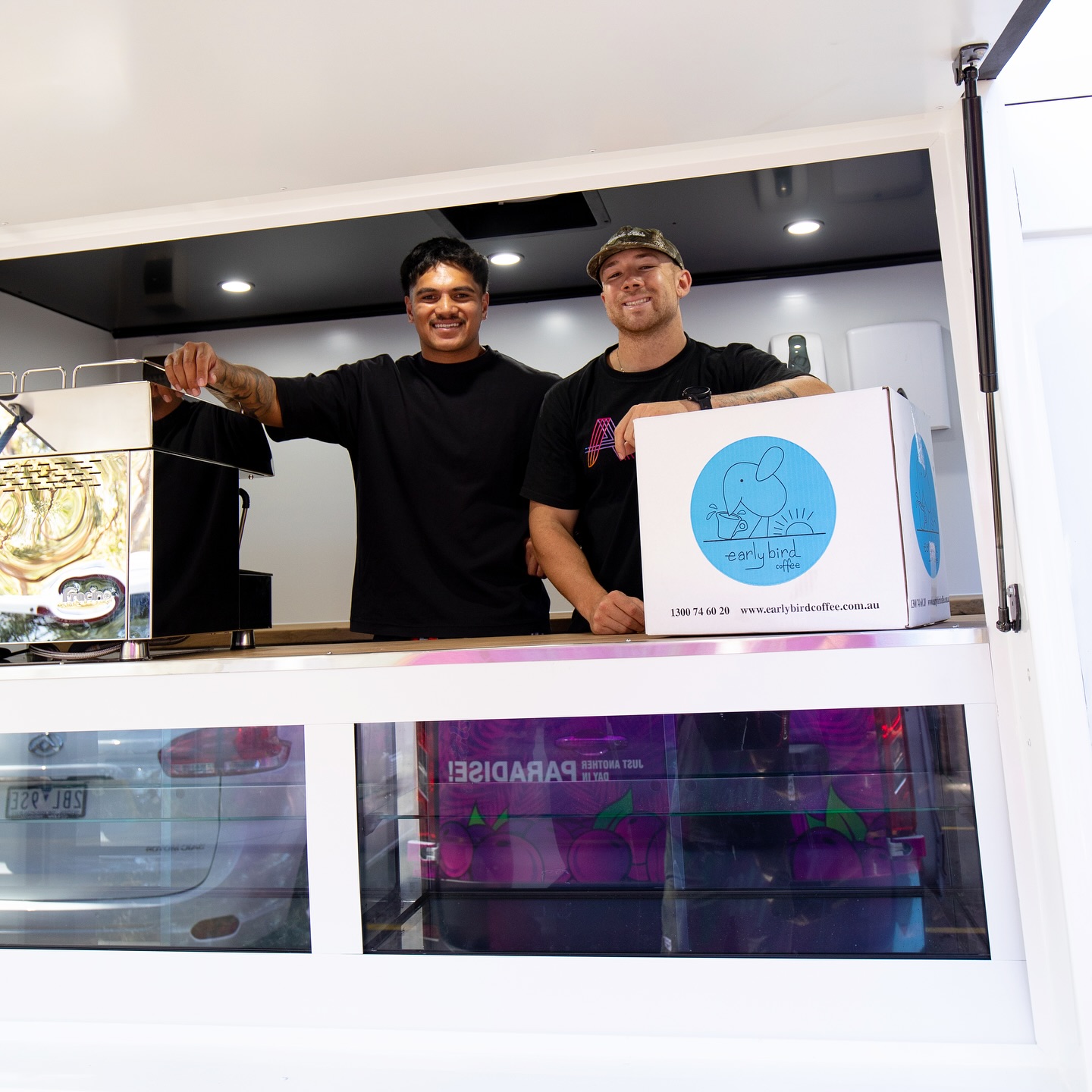 Two operators holding a box of freshly delivered Earlybird stock.
