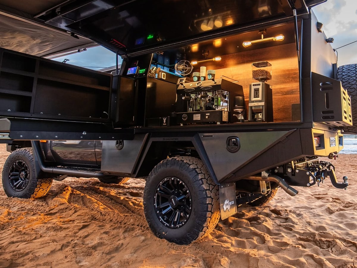 A ute tray fitted out as a mobile coffee bar with the canopy raised.