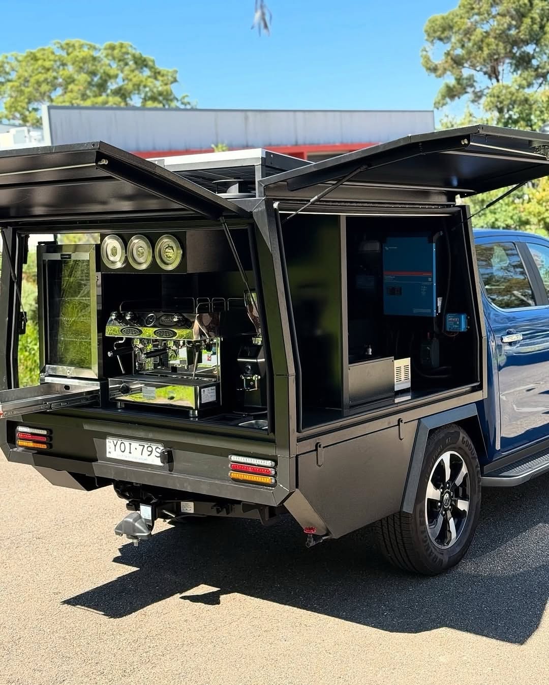 All-black coffee ute canopy, gullwing doors open