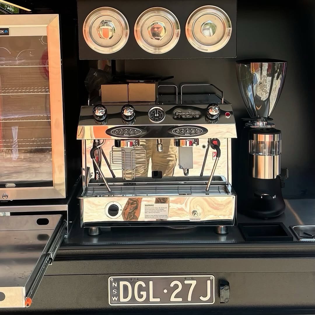 Espresso machine and grinder detail in a black ute canopy