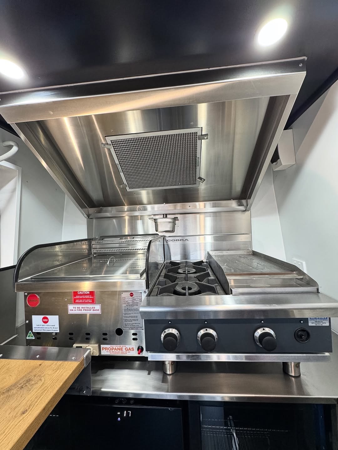 Gas cooktop detail with propane compliance signage