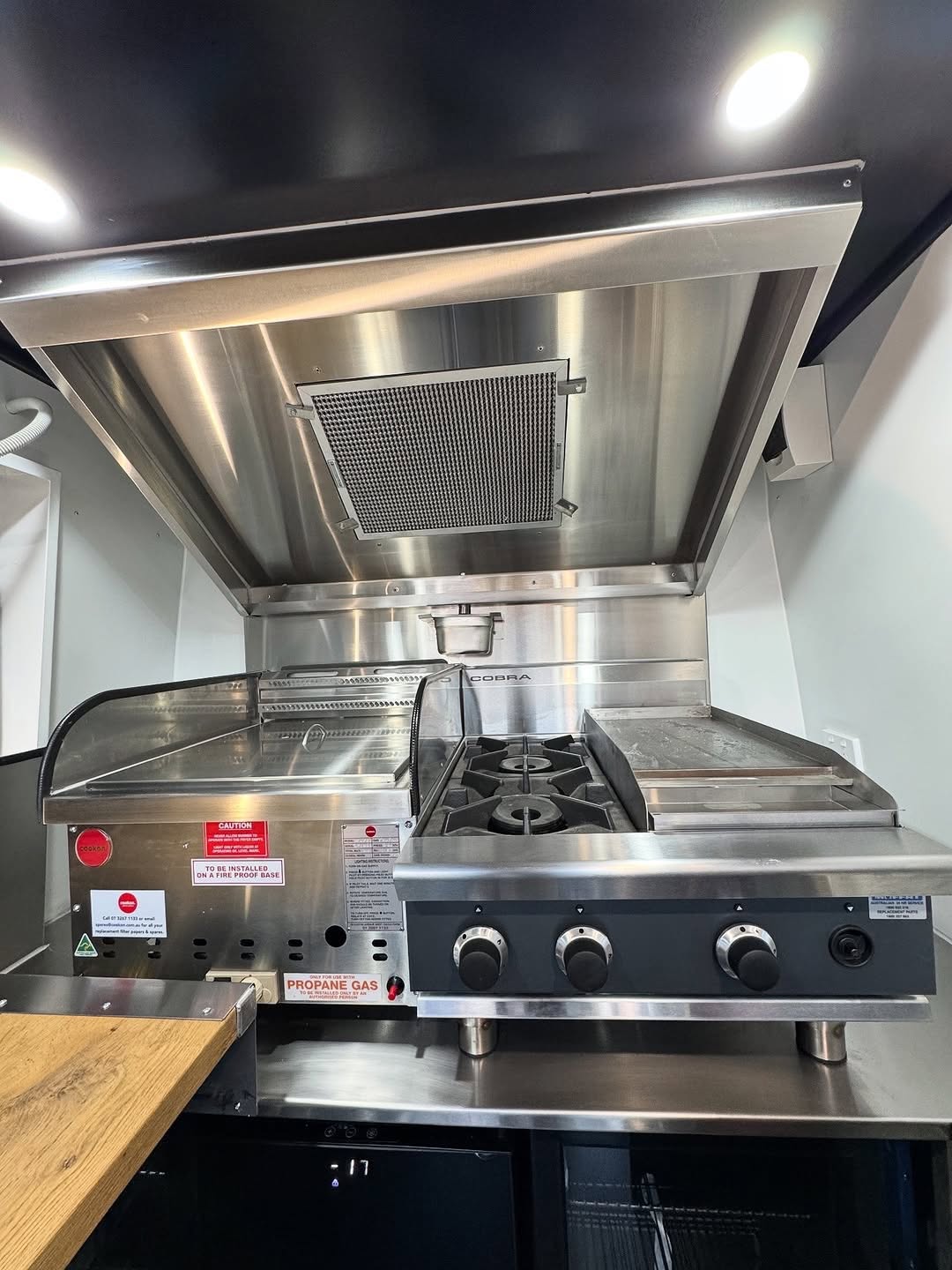 Food truck cook-line with extraction hood, griddle and gas burners