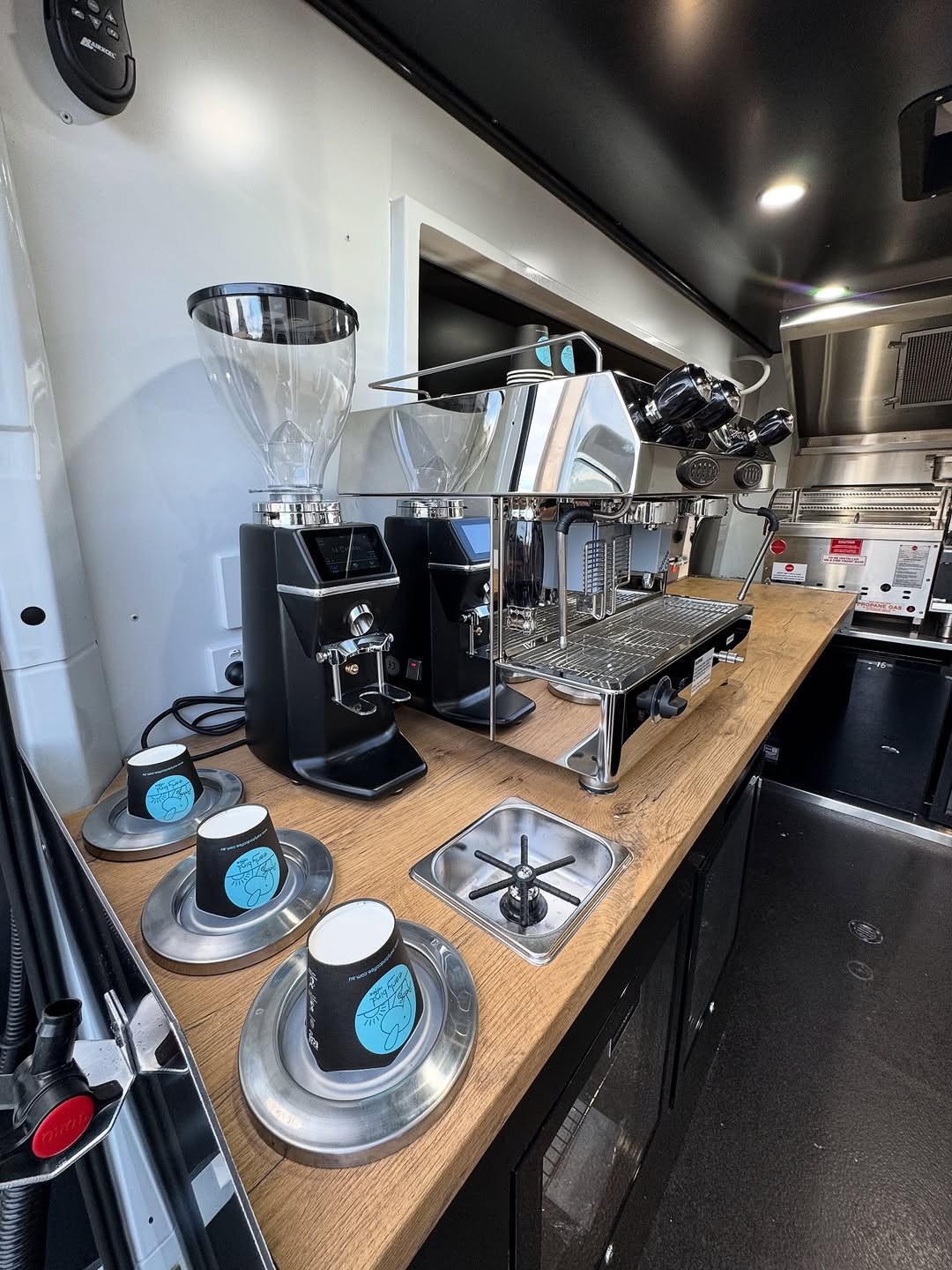 Espresso machine and grinders on timber bench