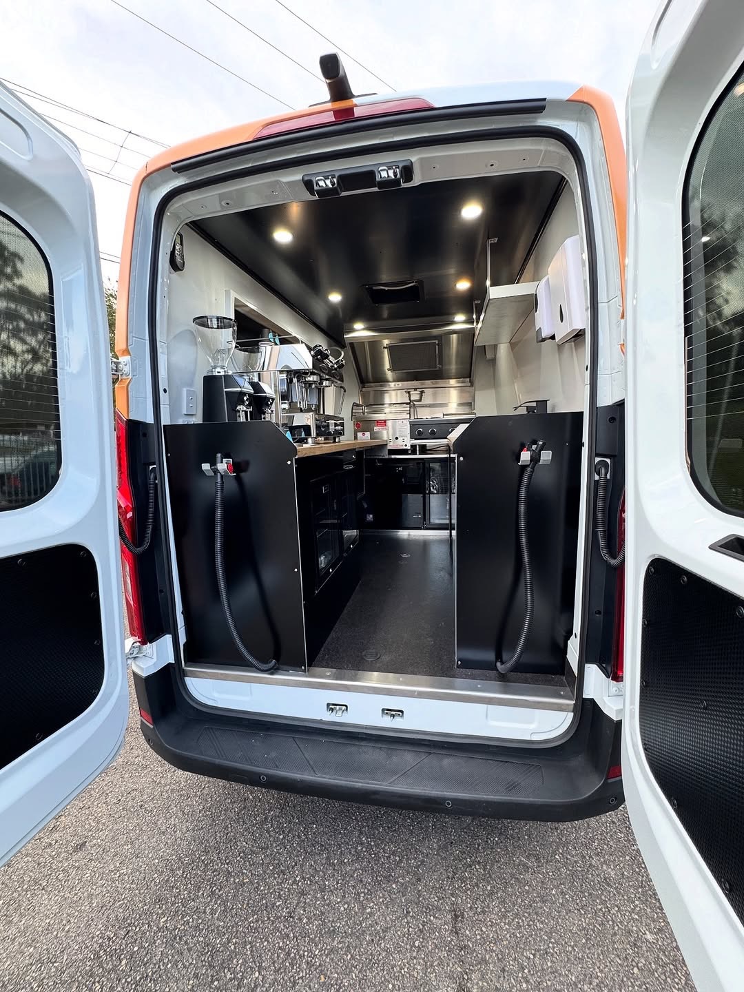 Food truck rear doors open showing interior fit-out