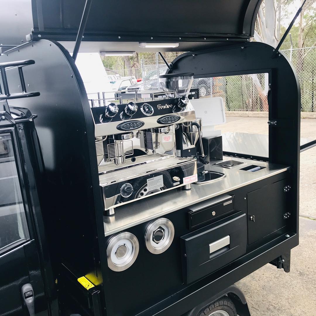 Close-up of espresso machine and till drawer on Ape tray