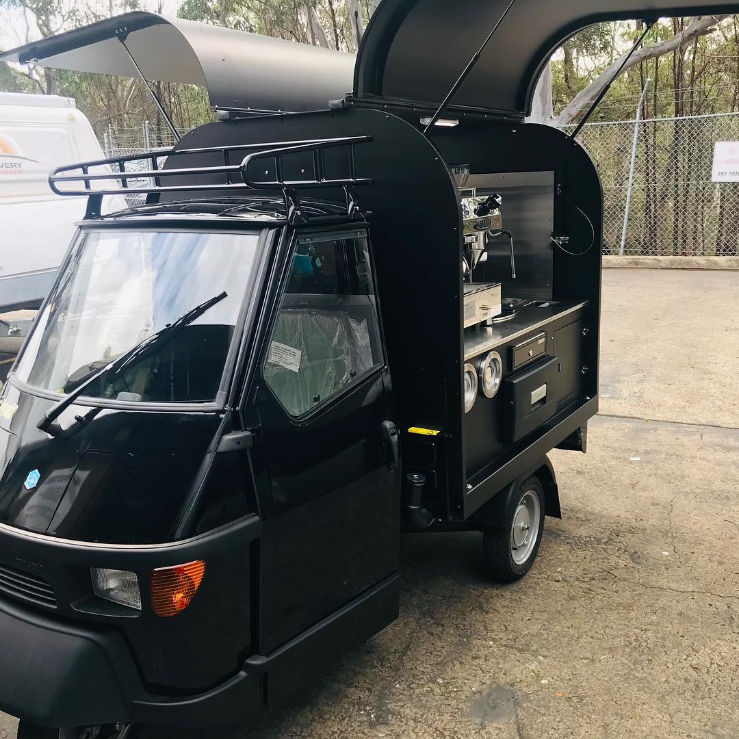 Black Piaggio Ape, side profile, canopy folded up