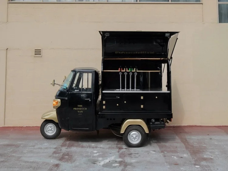 Black and gold Piaggio Ape fitted with beverage taps