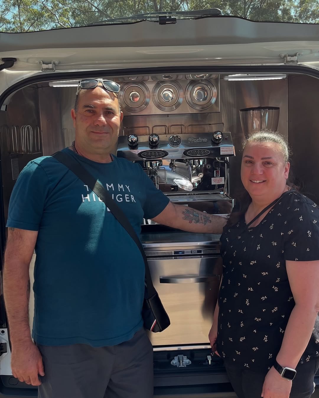 Two operators standing beside a finished rear hatch build