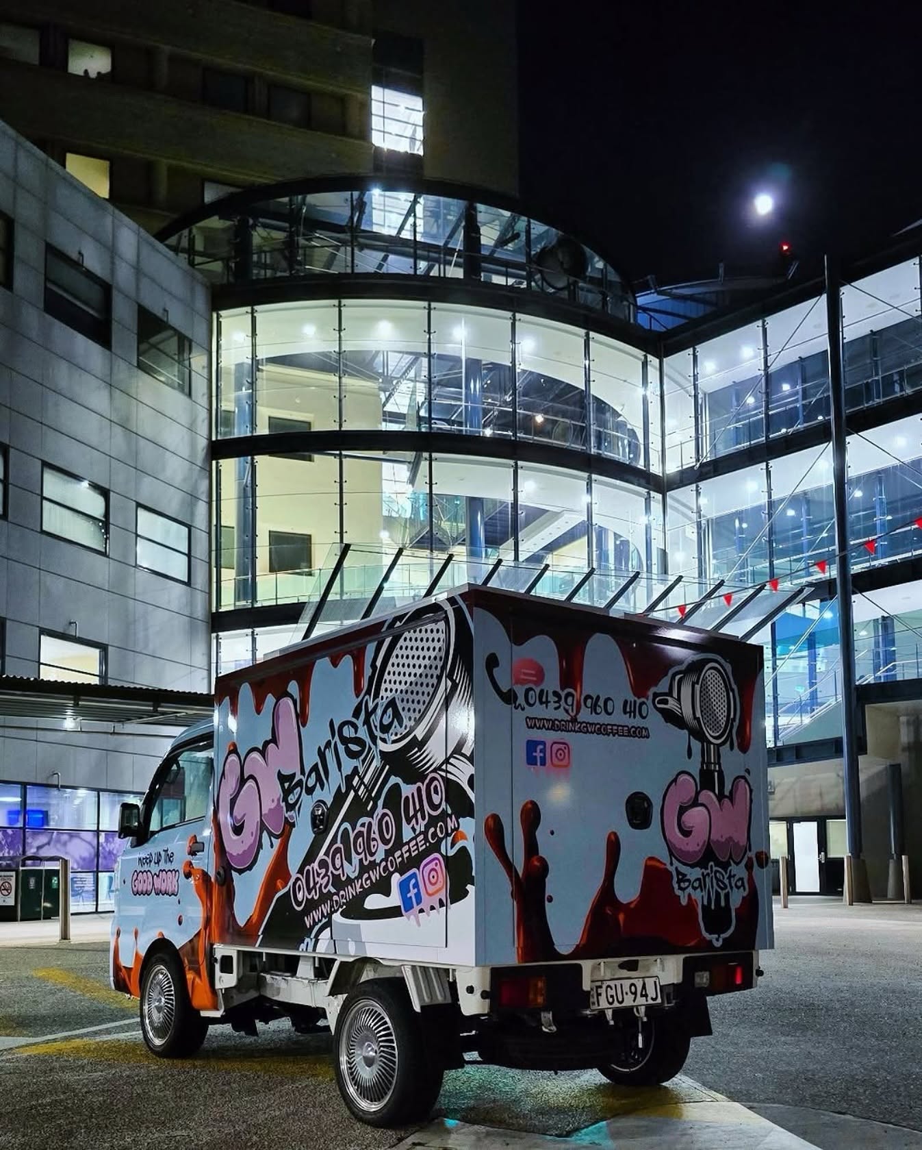 Box truck fully wrapped in custom graffiti coffee branding, night shot