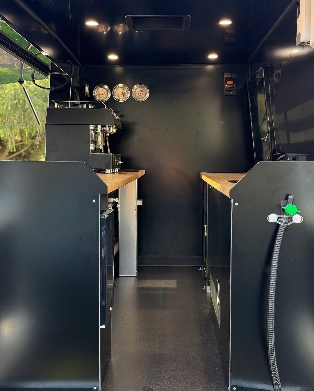 Unfitted walk-in shell, black cabinetry either side