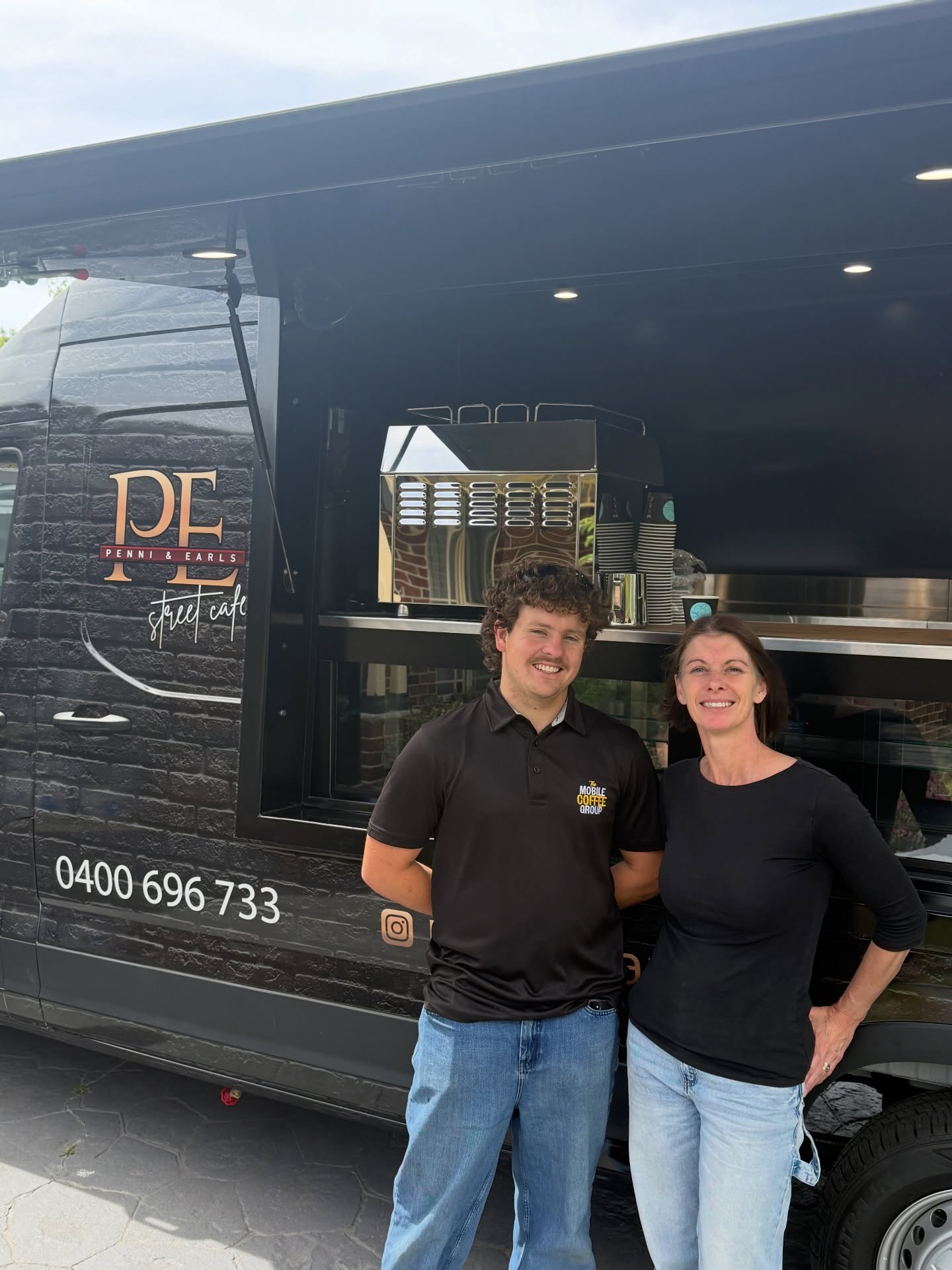 Penni and Earl's Street Cafe, operators beside their van